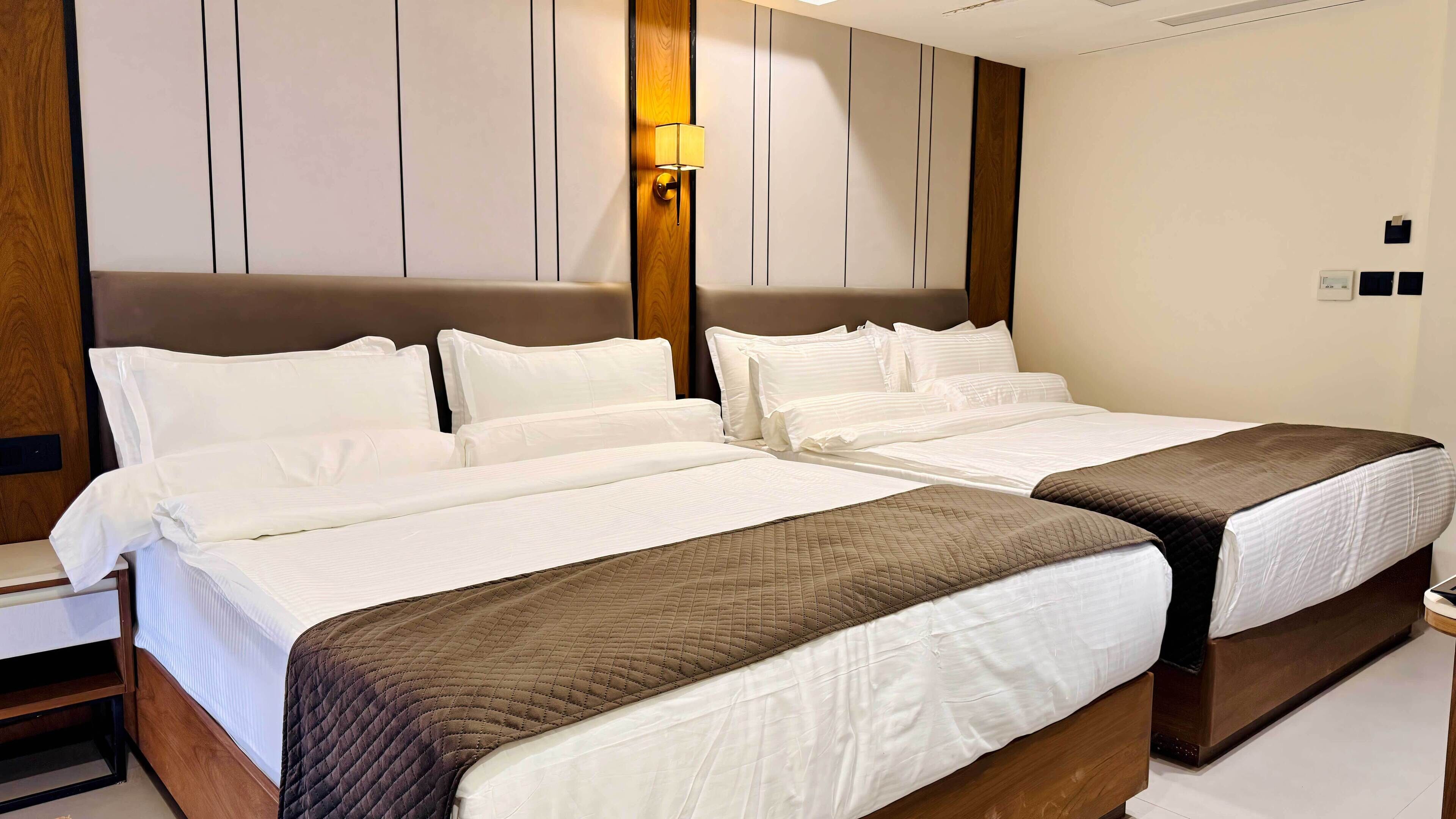 Standard Quadruple Room | In-room safe, desk, laptop workspace, blackout drapes