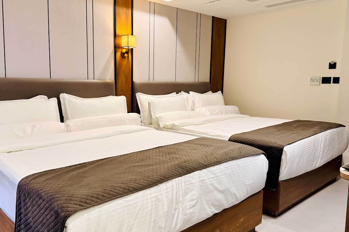 Standard Quadruple Room | In-room safe, desk, laptop workspace, blackout drapes