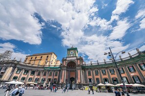 A historic building with a central clock tower, large open plaza, and surrounding cafes. - GREROS BOUTIQUE ANGIOINO by Clapa Group dislocated hospitality (Naples)