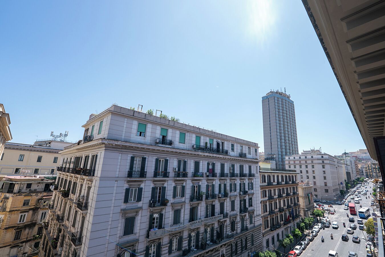 A multi-story building with a classic architectural style, featuring balconies and large windows.
