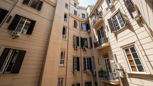 A multi-story building with balconies, air conditioning units, and a clear sky. - GREROS H. HISTORICAL AREA, by Clapa Group dislocated hospitality Acquisition (Naples)