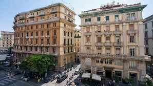 A multi-story building with a classical architectural style, featuring balconies and large windows. - GREROS TOLEDO H. by Clapa Group dislocated hospitality (Naples)
