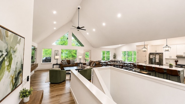 A spacious loft with a high ceiling, large windows, a kitchen with modern appliances, and a dining area. - 25% late summer discount!  9BR Theater Room Dock Slip in cove, Sleeps 30! (Lafollette)