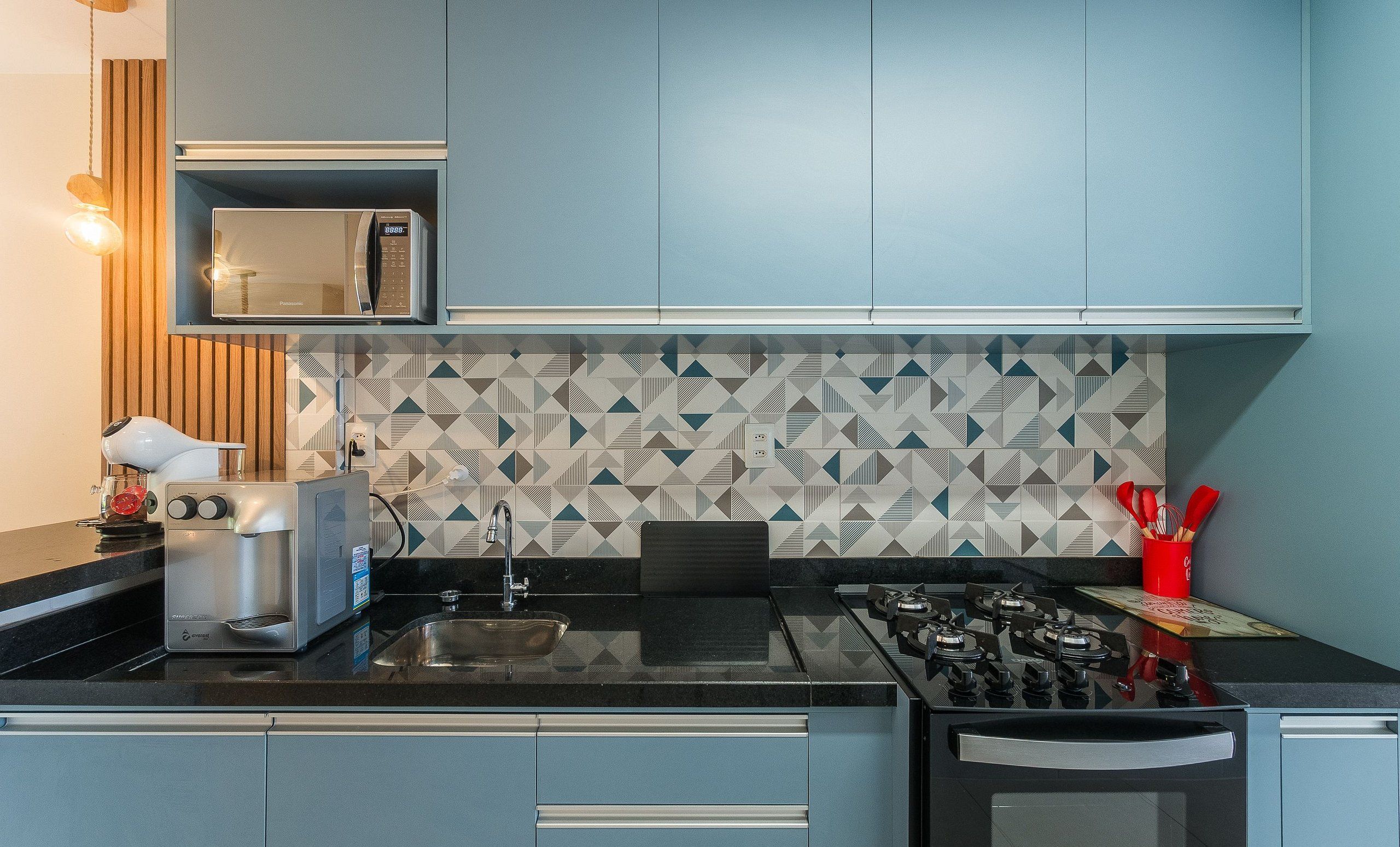 A modern kitchen with a microwave, toaster, and sink.