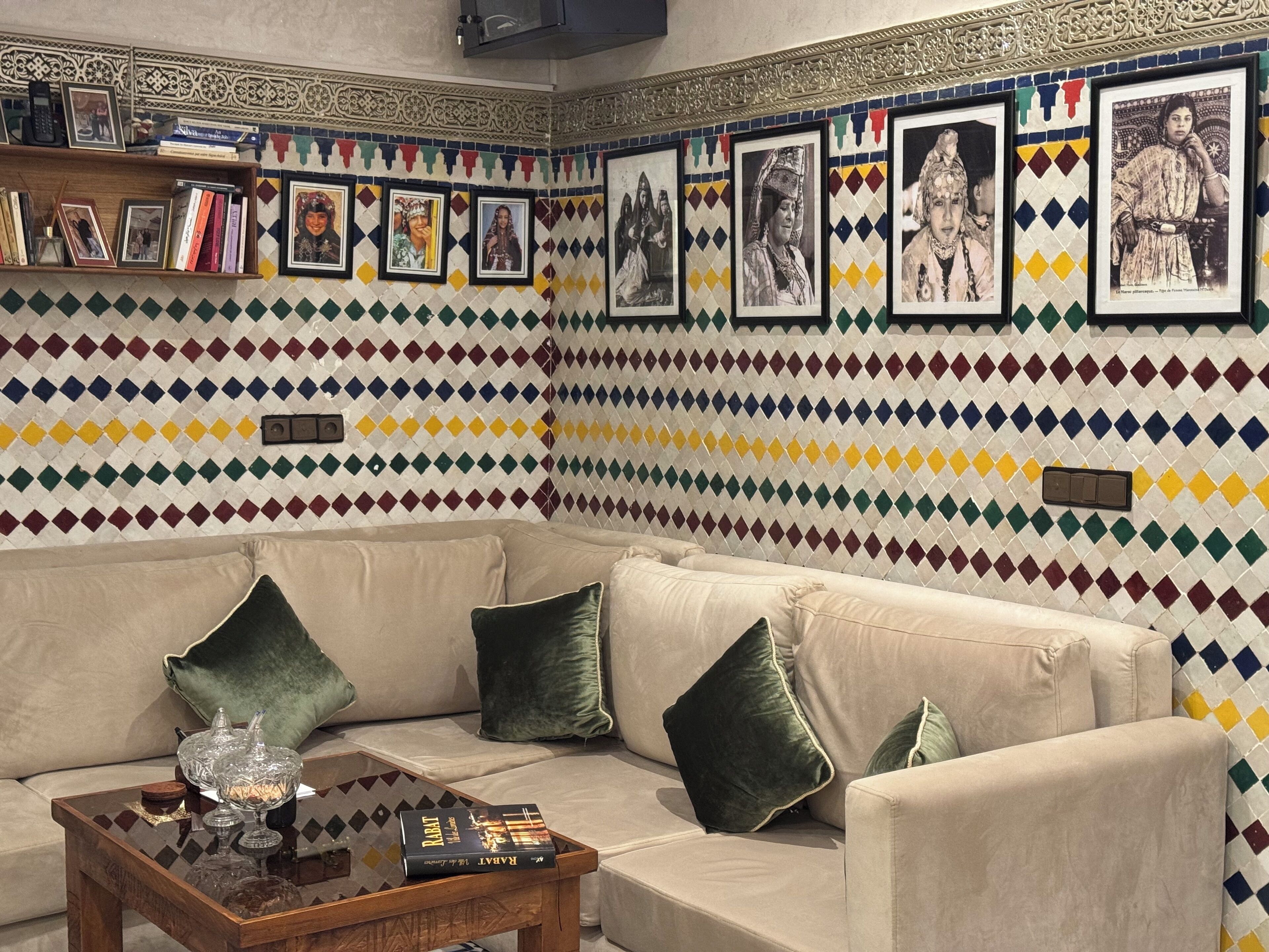 A living room with a patterned wall, a sofa, and a coffee table.