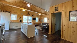 Una cabaña espaciosa con cocina, comedor y sala de estar.