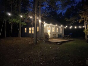 A house with a covered porch and string lights. - Long Lake Waterfront Cabin: Family Fun (Longville)