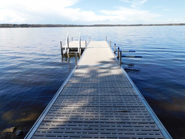 A wooden dock extending into calm water with a clear sky above. - Upper Hay Pet Friendly Getaway Home (Pequot Lakes)