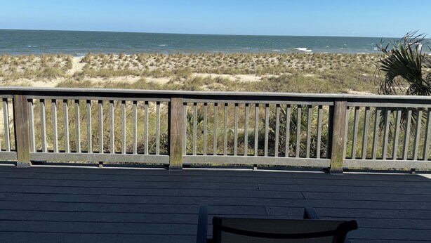 A wooden deck with a view of the ocean and dunes. - Oceanfront Tybee Island, a spacious home perfect for family vacations. (Tybee Island)