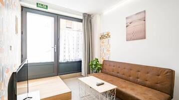 Standard Apartment | Living area | 30-inch Smart TV with digital channels