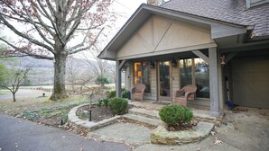 A house with a covered porch, stone steps, and a view of a tree and landscape. - Dug Hill Home with Patio, Pond & Fire Pit! (Brownsboro)