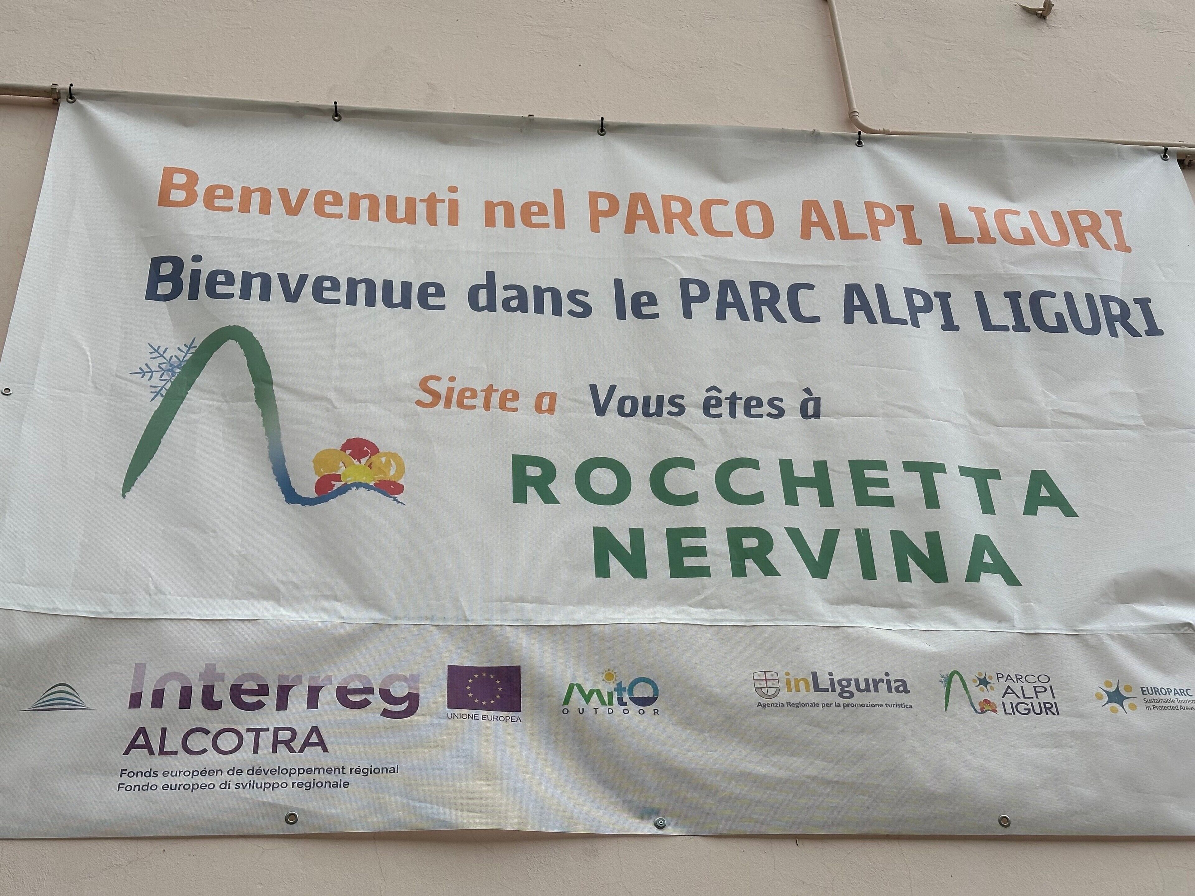 A welcome banner with text in multiple languages and logos of various organizations.