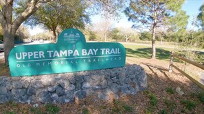 A sign for the Upper Tampa Bay Trailhead, indicating the entrance to the Old Memorial Trailhead. - CASA KAMPA offers you a heated pool with Jacuzzi at no additional cost. (Tampa)