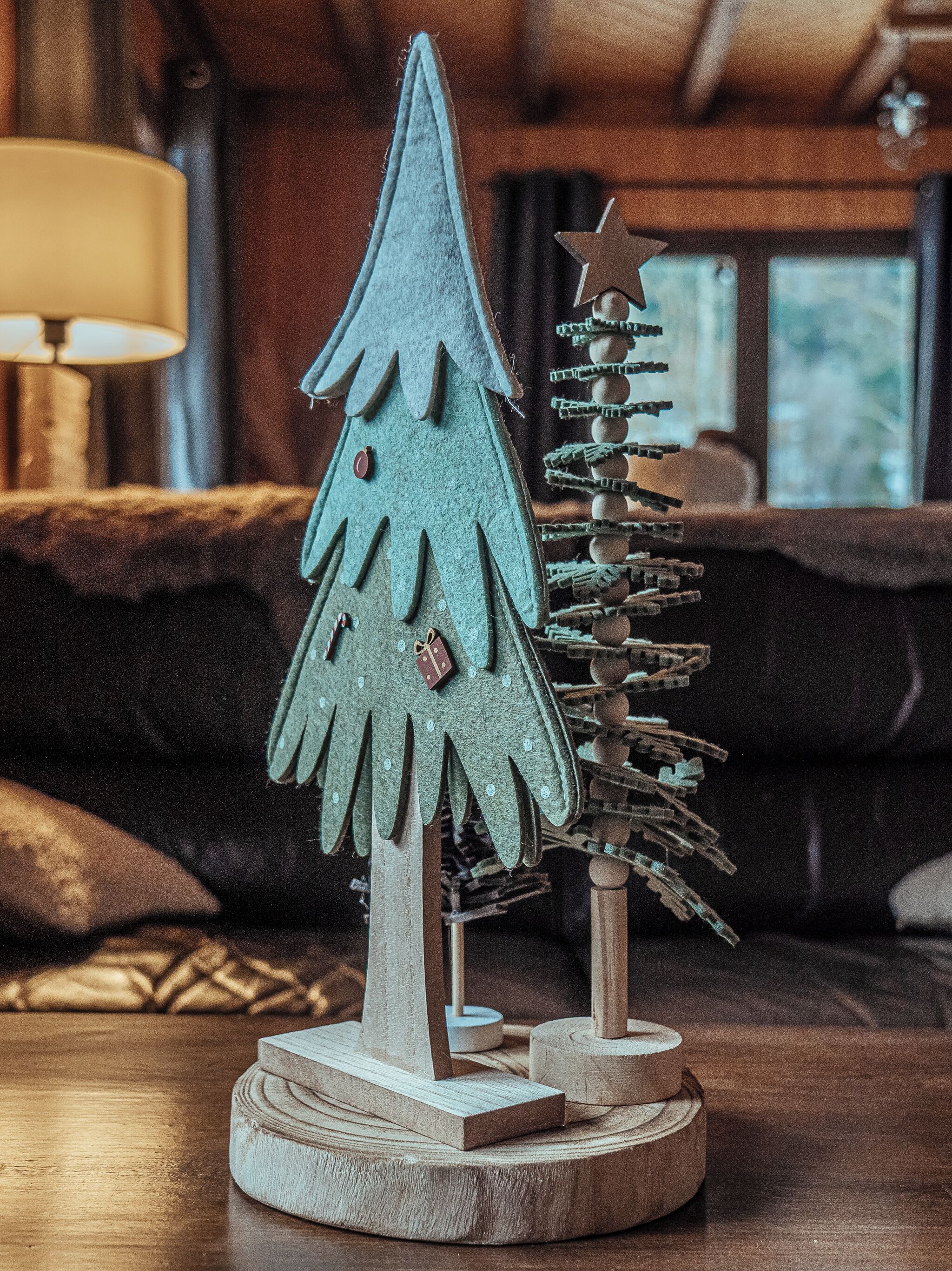 A wooden Christmas tree and star decoration on a table.