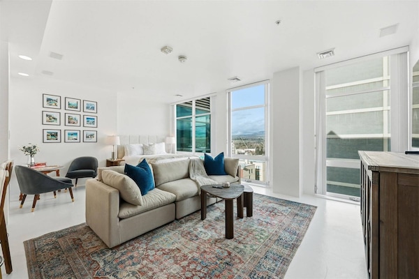 Floor-to-ceiling windows showcasing sweeping city and horizon views