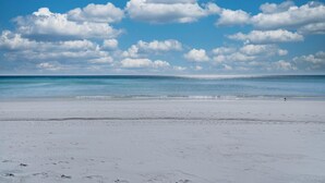 A beach with a clear sky and calm sea. - Harbor Landing 102b (Destin)