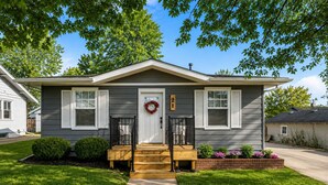 A two-story house with a front porch, a front door with a wreath, and a mailbox. - New Farmhouse, Kitchen & Coffee Bar, Near Hospital (Johnstown)