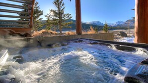 Un bain à remous avec vue sur les montagnes et les arbres.