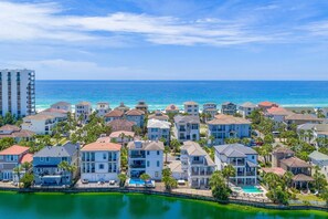 A coastal residential area with houses, a swimming pool, and a view of the ocean. - Nana's Beach House (Destin)