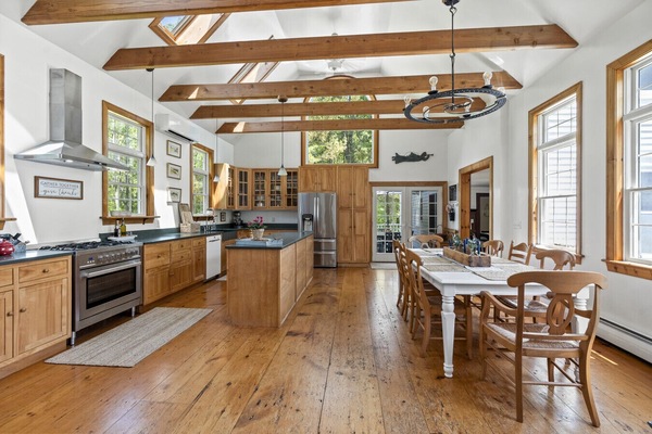 Beautiful open-concept kitchen area with high ceilings and plenty of natural light