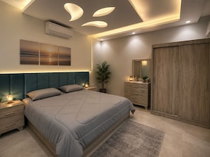 Un dormitorio moderno con una cama grande, mesitas de noche, un aparador, un espejo y una lámpara en el techo.