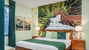 A neatly made bed with a green blanket, two bedside lamps, and a wooden nightstand. - Forest Retreat • Theater • Full Spa • Speakeasy • GameRoom • MORE (East Stroudsburg)