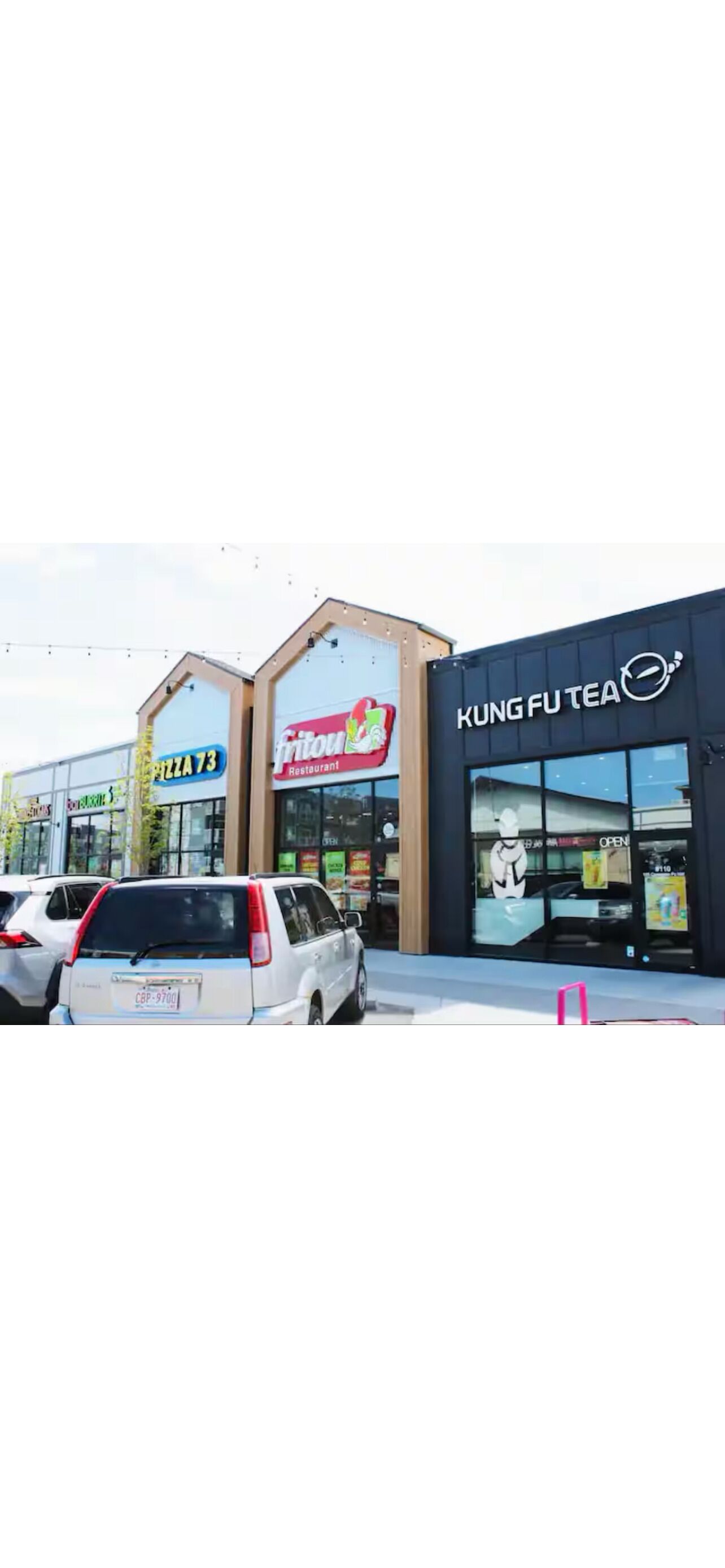 A commercial building with signs for 'Pizza 73' and 'Fritou Restaurant'.