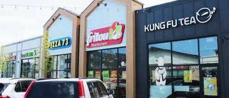 A commercial building with signs for 'Pizza 73' and 'Fritou Restaurant'.