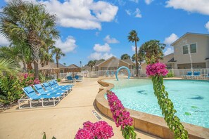 A pool area with lounge chairs, a swimming pool, and a house in the background. - !NEW LISTING! Surf Shack, Sleeps 4, Heated pool (Corpus Christi)