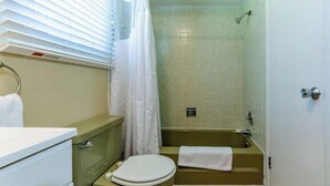 A bathroom with a toilet, sink, and bathtub. - Lakefront King with full kitchen (Whitehall)