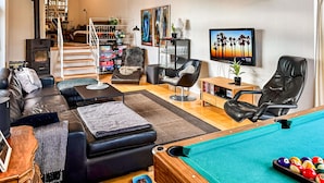 A modern living room with a pool table, leather sofas, a bookshelf, and a fireplace. - Pet friendly home in Ebeltoft with WiFi (Ebeltoft)