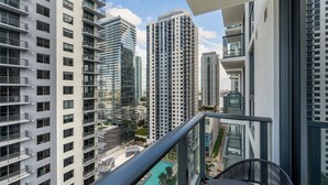 A high-rise building with multiple balconies, a pool, and a view of other buildings. - Crosby Miami WTC 1BR/1BA Downtown Gem #2713 (Miami)