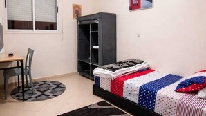A bedroom with a bed, a desk, a chair, a wardrobe, and a window. - Cozy Room Ain Chock Near Casa Nearshore (Casablanca)