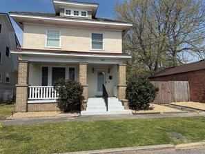 A two-story house with a front porch, a mailbox, and a number '803' on the door.