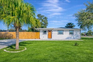 A single-story house with a front door, windows, and a lawn. - Poolside Playhouse - Pool Home - 5 Min. To Beach (Seminole)