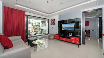 Deluxe Apartment, 1 Bedroom, Balcony, City View (Absolutely Amazing Bangla 1BR Suite) | Living area | 55-inch Smart TV with digital channels