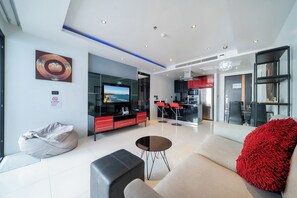 Deluxe Apartment, 1 Bedroom, Balcony, City View (Absolutely Amazing Bangla 1BR Suite) | Living area | 55-inch Smart TV with digital channels - Absolutely Amazing Bangla 1Br Suite (Patong)