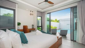 A modern bedroom with a large bed, a desk, and a view of a swimming pool. - Nicky Elegant 3Br Pool Villa Bangtao (Choeng Thale)