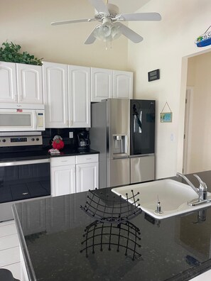 Fridge, microwave, oven, stovetop - Villa Caribbean is a 3 Bedroom / 3 Bathroom canal-front Villa designed for up to six guests (Cape Coral)