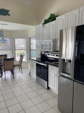 Fridge, microwave, oven, stovetop - Villa Caribbean is a 3 Bedroom / 3 Bathroom canal-front Villa designed for up to six guests (Cape Coral)