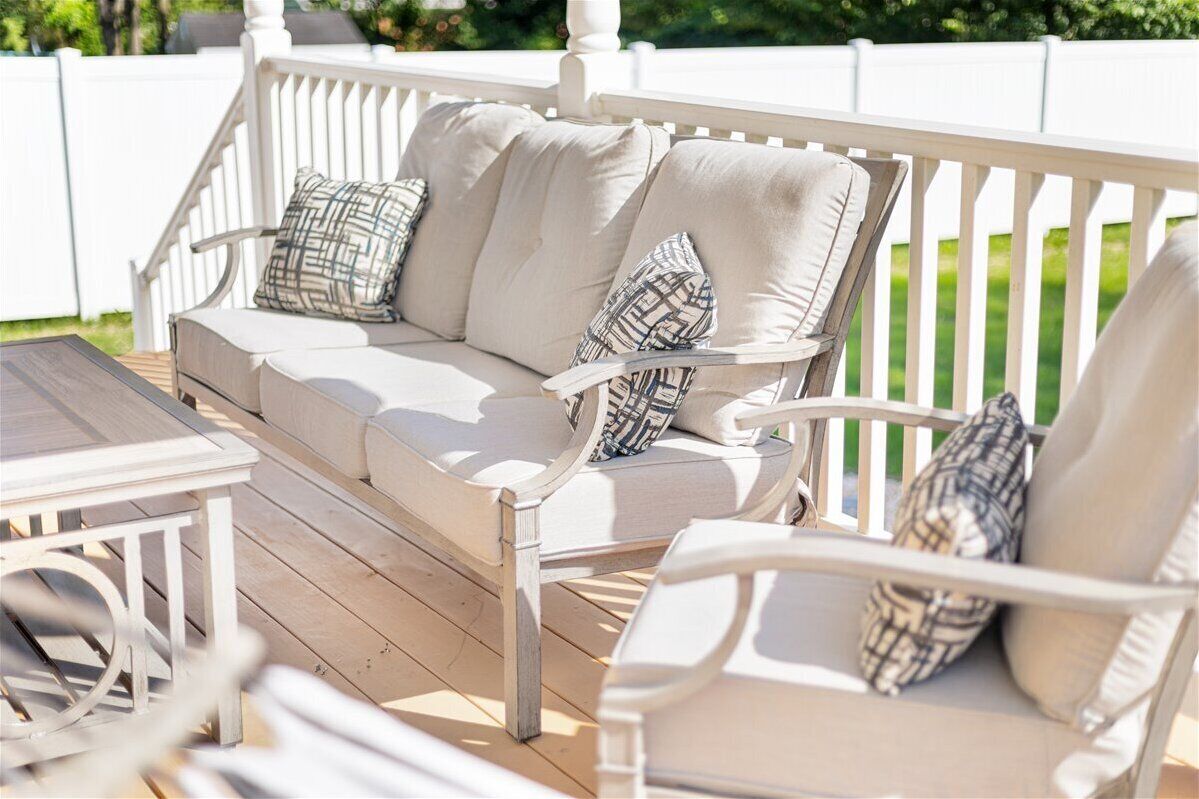 Comfortable covered-deck seating overlooking the yard.