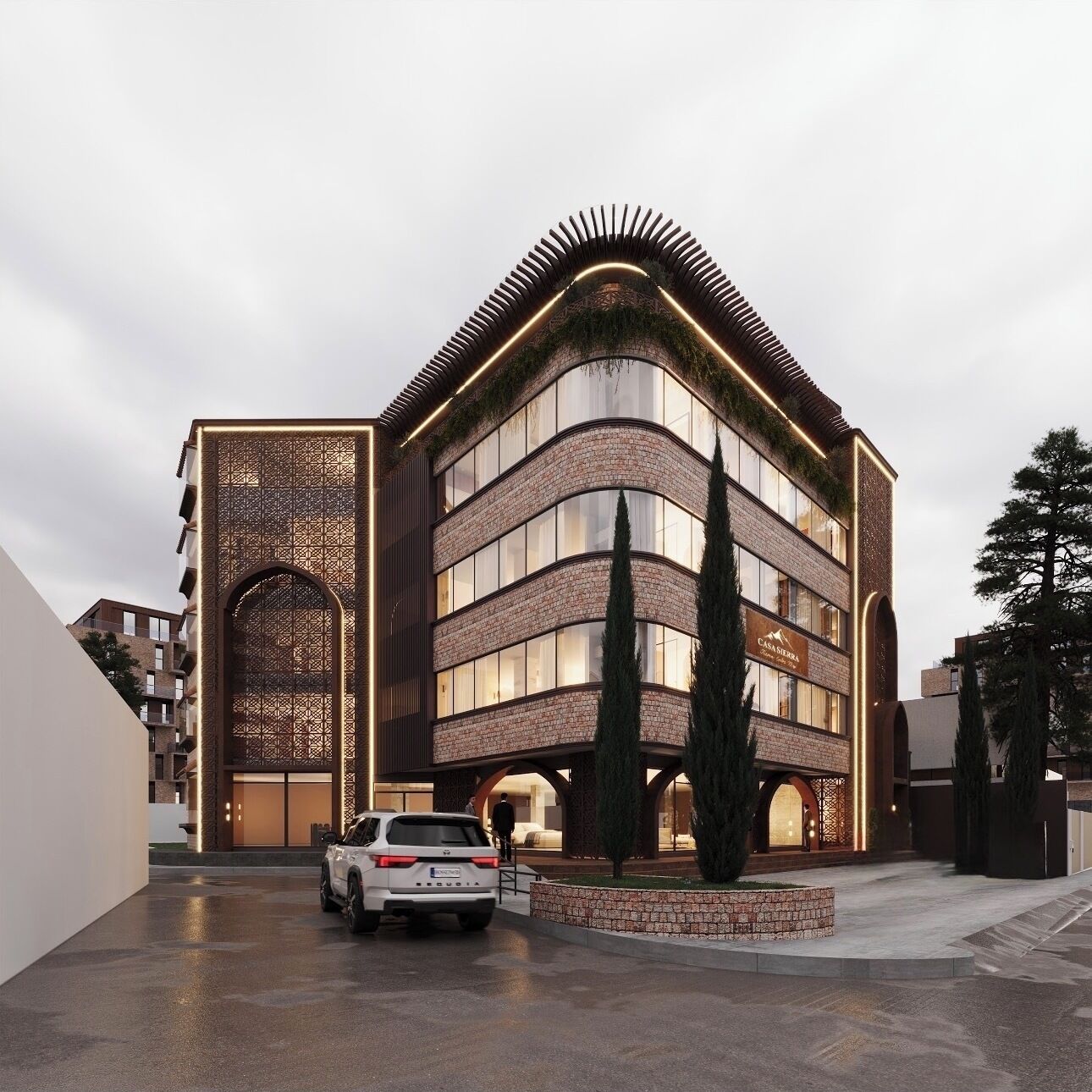 Un bâtiment moderne doté d’une façade incurvée, de grandes fenêtres et d’une entrée imposante surmontée d’une arche décorative.