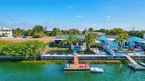 A waterfront property with a dock, boats, and a swimming pool. - Waterfront Canal Hot Tub Kayaks (Hernando Beach)