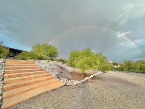A gravel driveway with a wooden staircase leading up to a house. - Private Desert Retreat in the Catalina Foothills (Tucson)