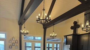 A modern kitchen with a central island, bar stools, and pendant lighting. - Enjoy beautiful sunsets at Blue Bird Cove on Lewis Smith Lake with private dock. (Crane Hill)
