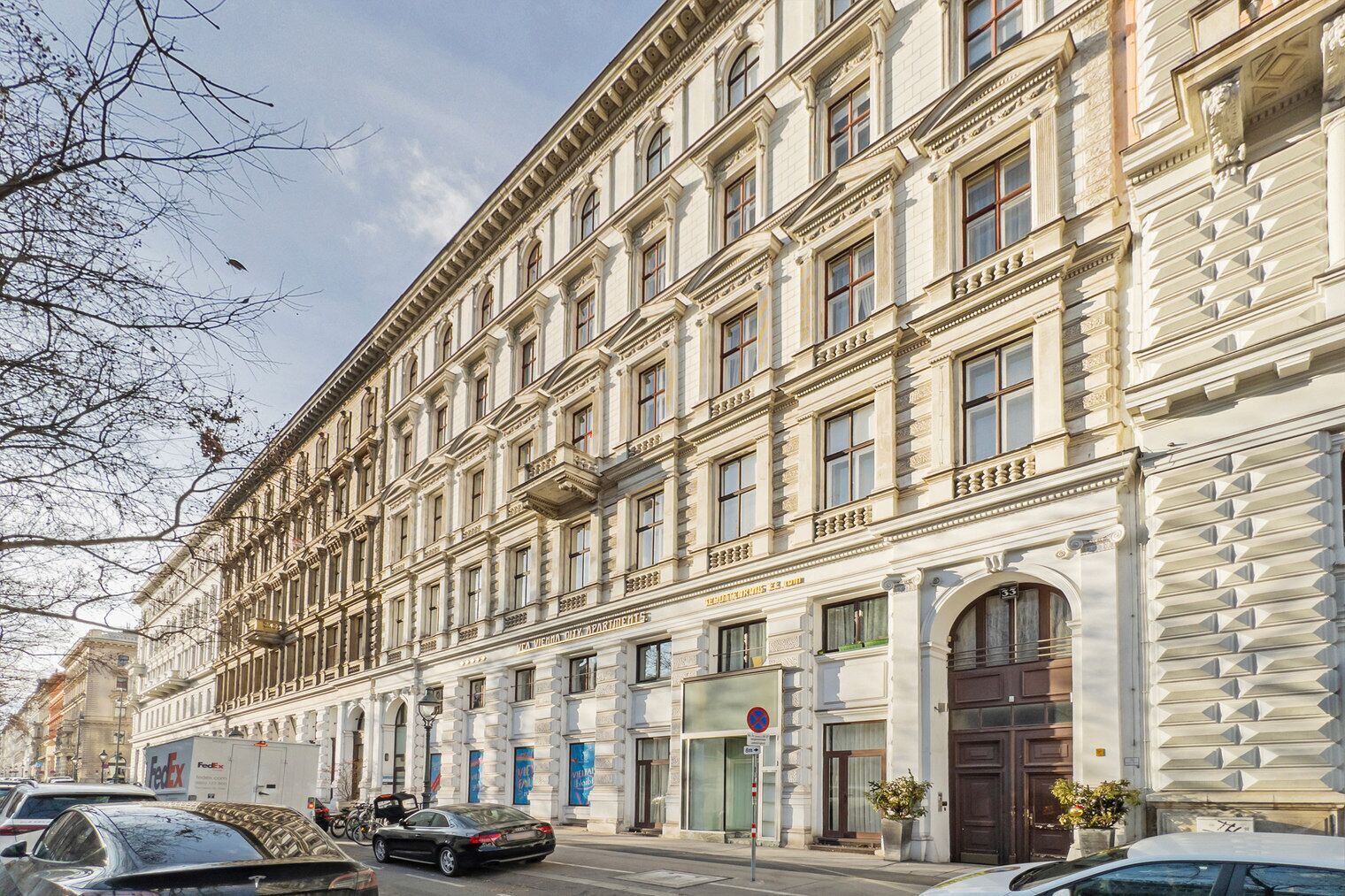 A multi-story building with a classical architectural style, featuring a row of windows and balconies.