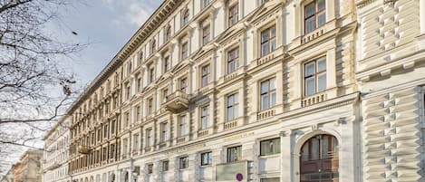 A multi-story building with a classical architectural style, featuring a row of windows and balconies.