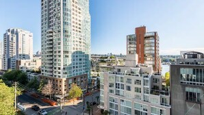 A high-rise building with a modern architectural design, featuring multiple balconies and large windows. - Luxury 2-bedroom condo beach side Yaletown (Vancouver)