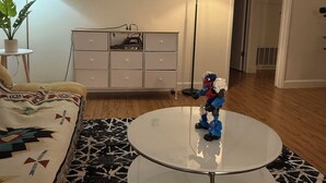 A living room with a sofa, a coffee table, a floor lamp, a painting, and a dresser. - Charming 3-bedroom apartment in Los Angeles perfect for your stay (Los Angeles)