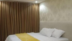 Une chambre à coucher moderne avec un lit, des rideaux et un sol à motifs.